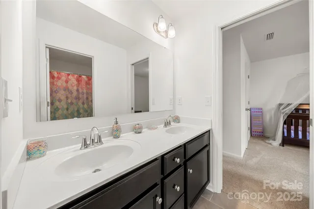 a bathroom with a double vanity sink and a mirror