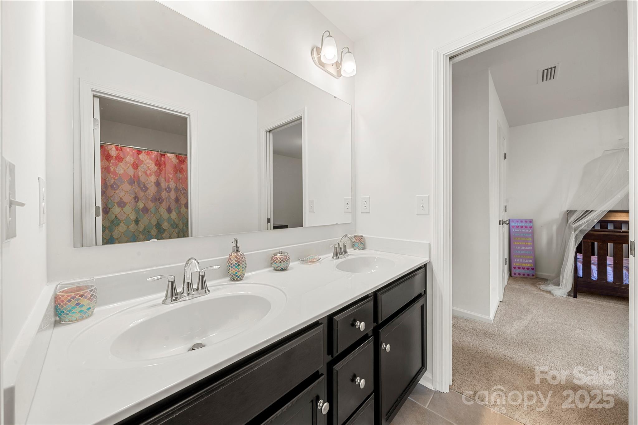 12053 Sam Snead Court Lancaster, SC 29720 - Photo 24 of 48 a bathroom with a double vanity sink and a mirror