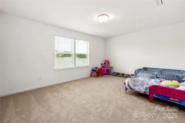 a bedroom with two beds and a window