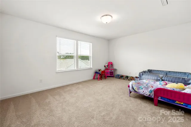 a bedroom with two beds and a window