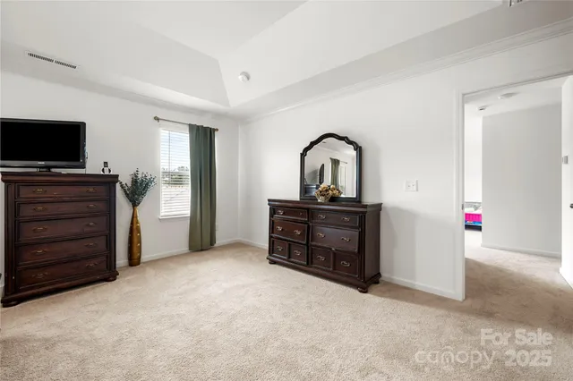 a room with furniture a flat screen tv and dresser