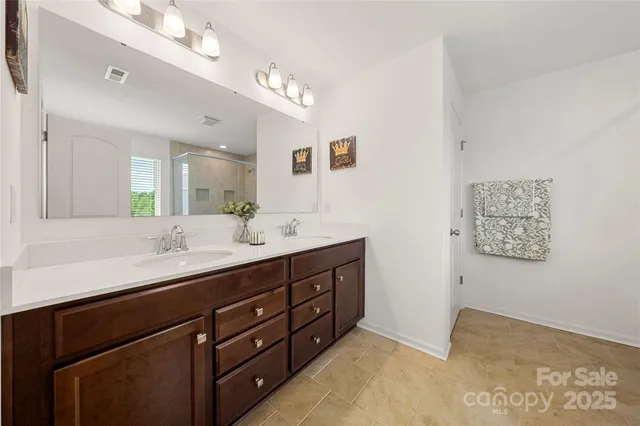 a bathroom with a double vanity sink and a mirror