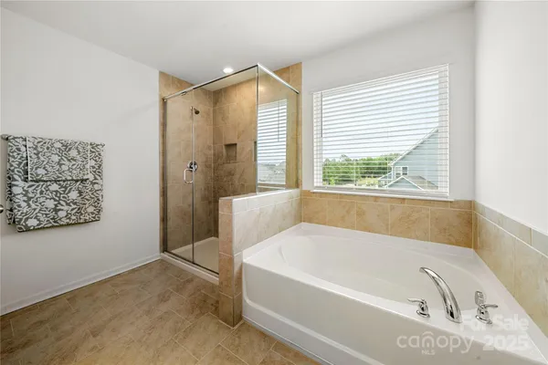 a bathroom with a bathtub and a shower
