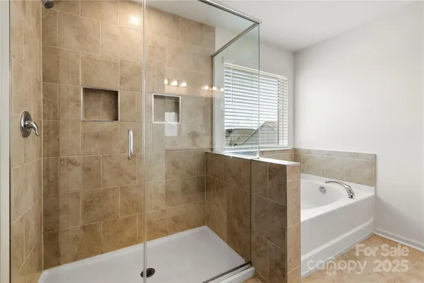 a bathroom with a bathtub and shower