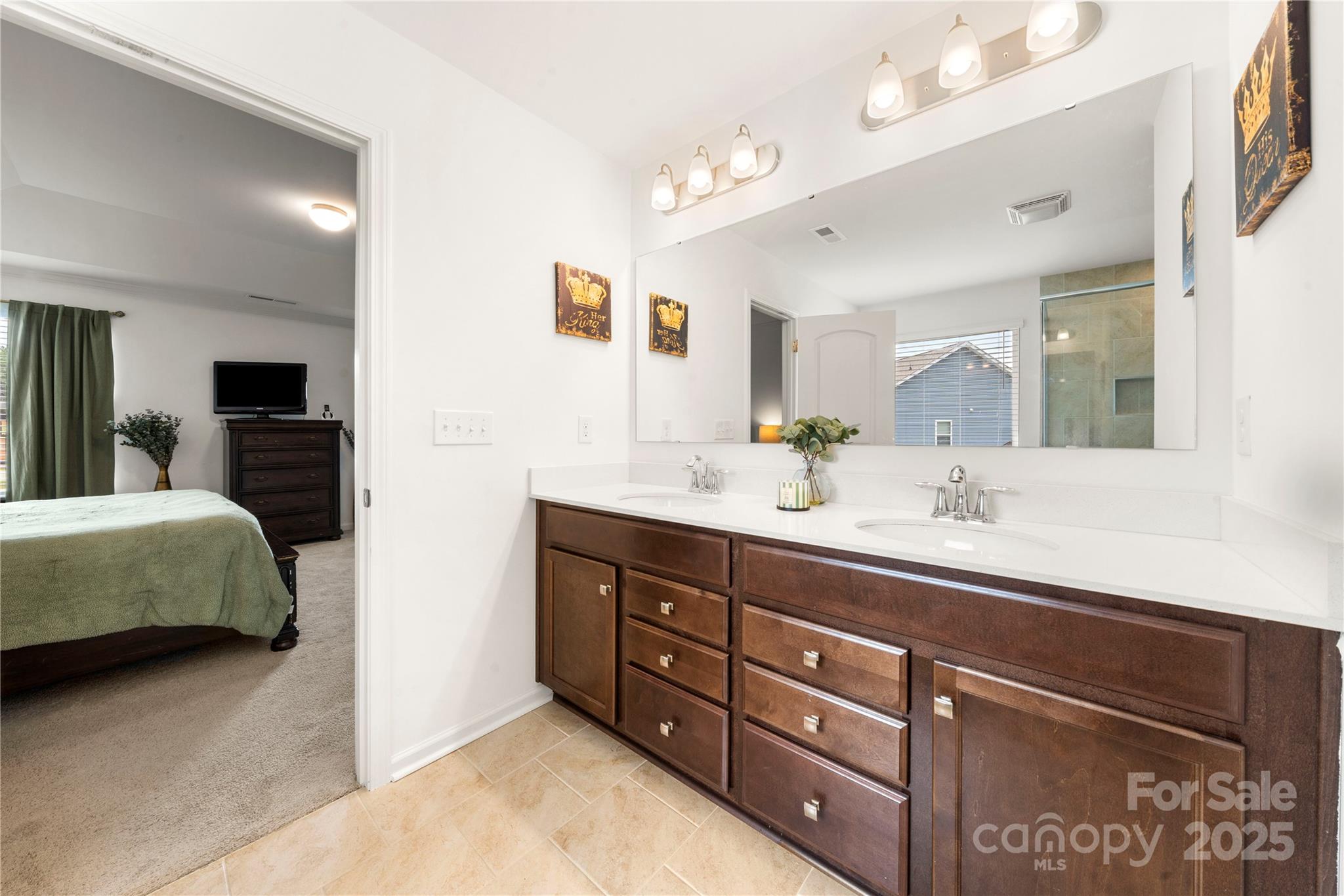 12053 Sam Snead Court Lancaster, SC 29720 - Photo 39 of 48 a spacious bathroom with a double vanity sink double and a mirror