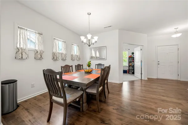 a view of a dining room with furniture and window