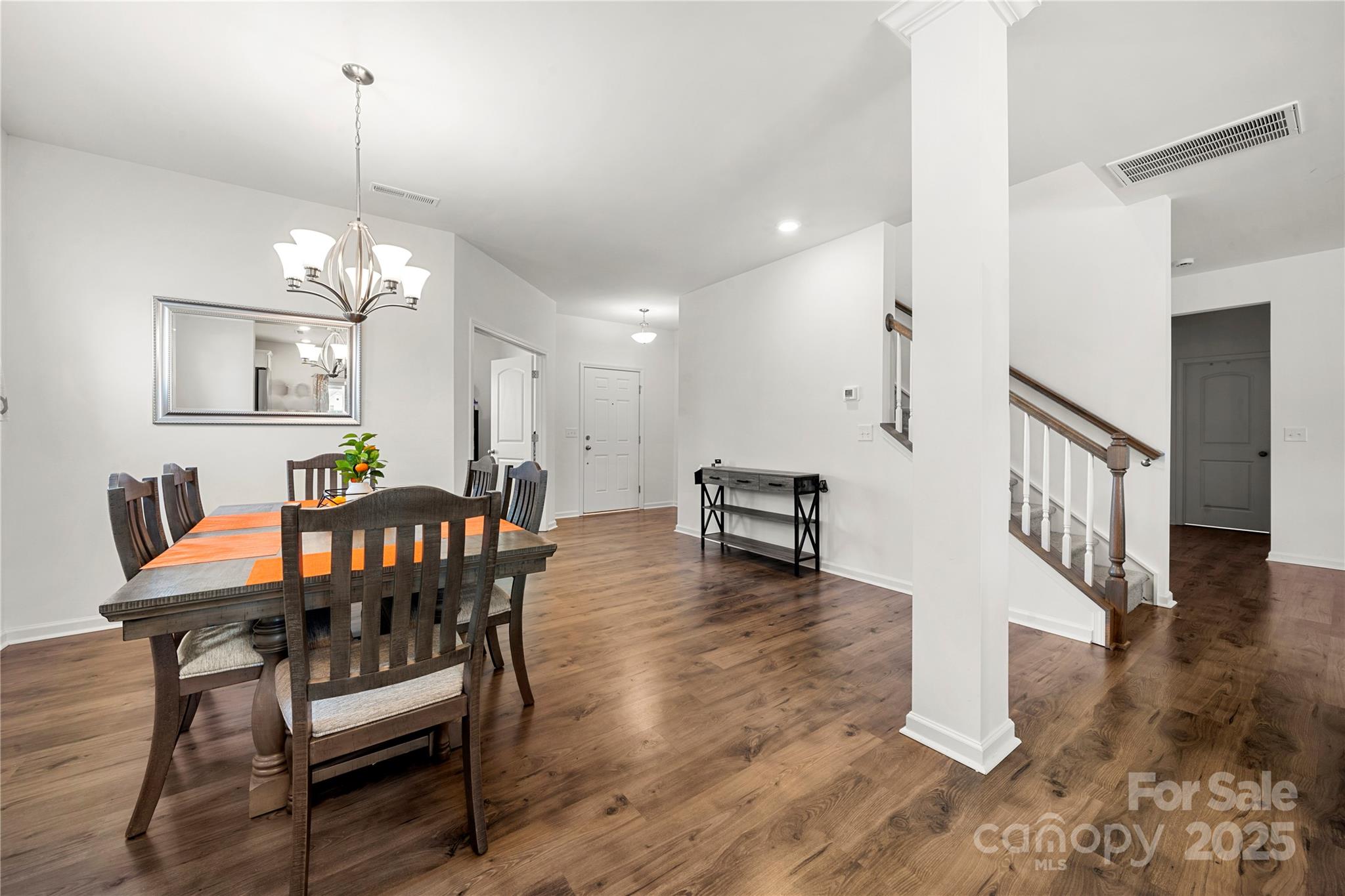 12053 Sam Snead Court Lancaster, SC 29720 - Photo 8 of 48 a dining room with furniture a chandelier and wooden floor