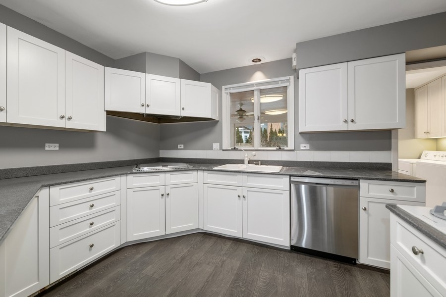 643 Robin Lane Glencoe, IL 60022 - Photo 12 of 32 a kitchen with granite countertop white cabinets and stainless steel appliances