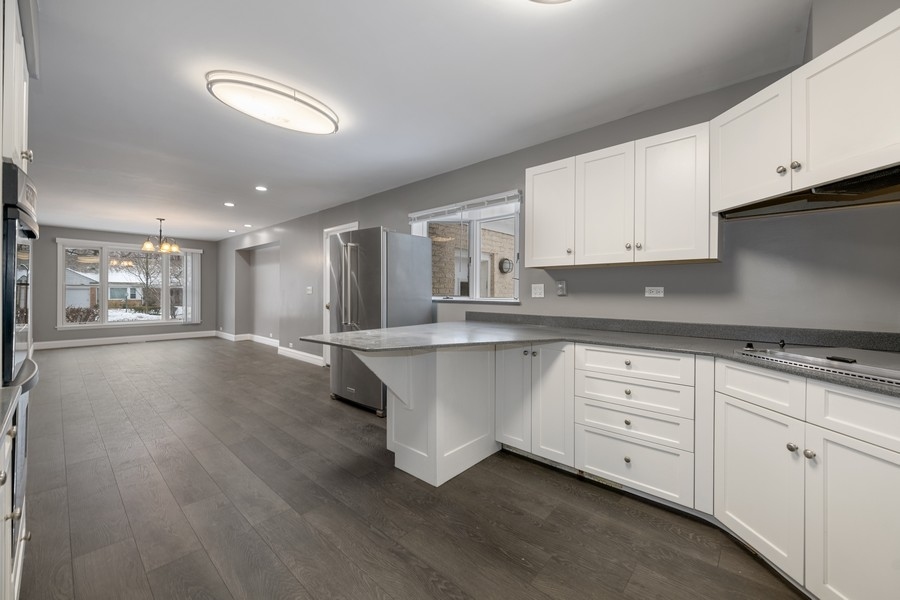 643 Robin Lane Glencoe, IL 60022 - Photo 13 of 32 a kitchen with stainless steel appliances granite countertop a stove a sink and white cabinets