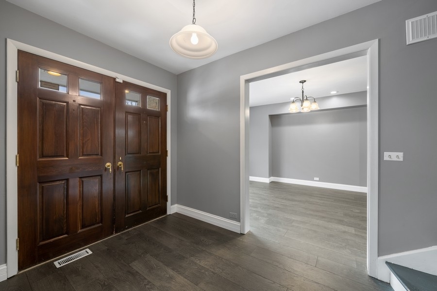 643 Robin Lane Glencoe, IL 60022 - Photo 2 of 32 an empty room with wooden floor mirror and windows
