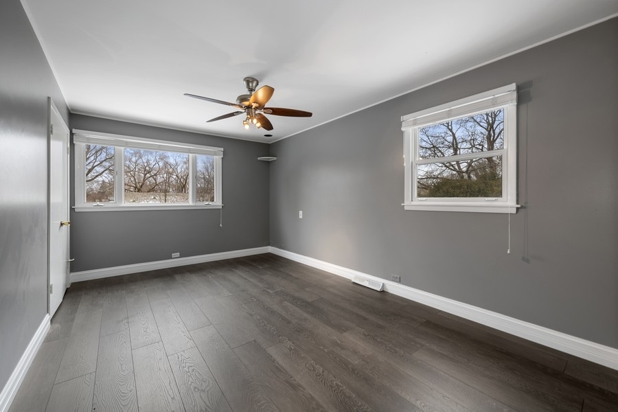 643 Robin Lane Glencoe, IL 60022 - Photo 22 of 32 a view of an empty room with window and wooden floor