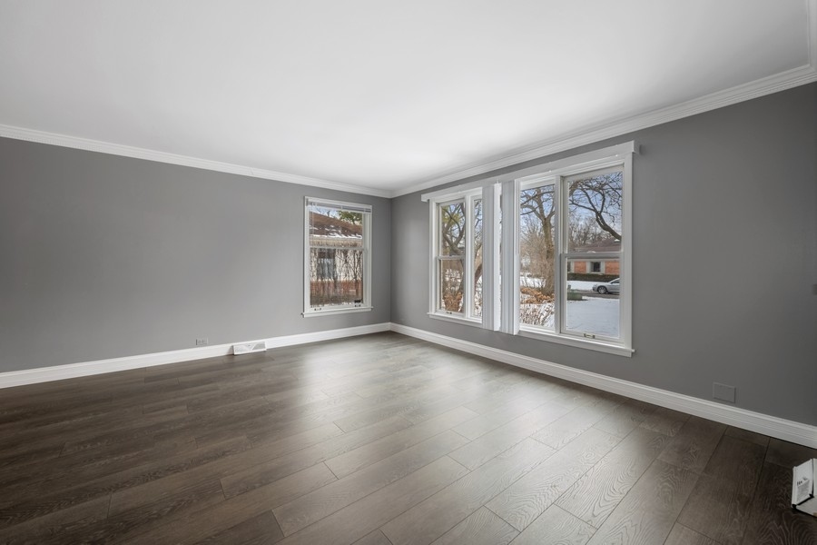 643 Robin Lane Glencoe, IL 60022 - Photo 4 of 32 a view of an empty room with wooden floor and a window