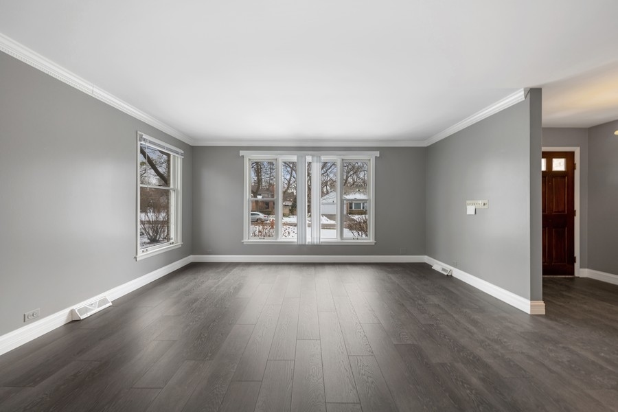 643 Robin Lane Glencoe, IL 60022 - Photo 5 of 32 an empty room with wooden floor and windows