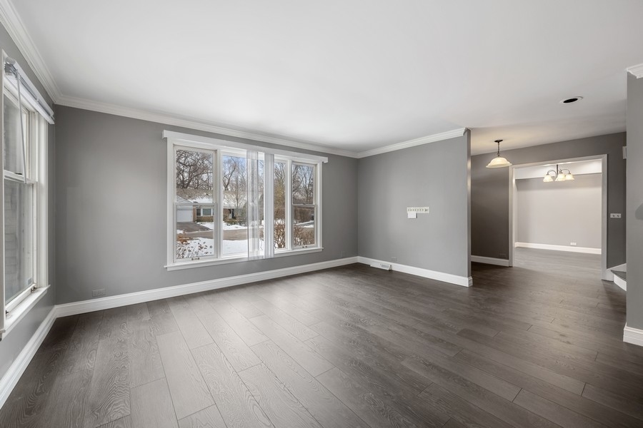643 Robin Lane Glencoe, IL 60022 - Photo 6 of 32 a view of an empty room with wooden floor and a window