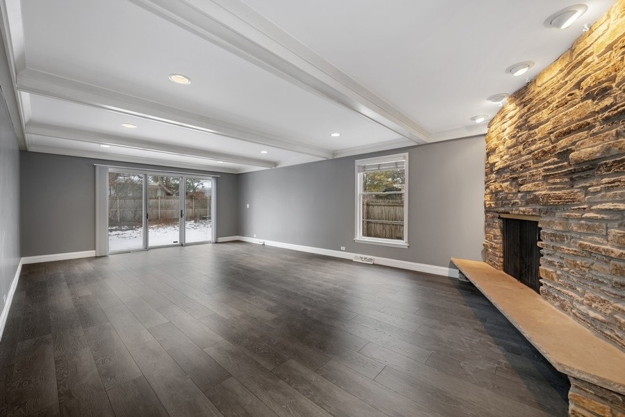 643 Robin Lane Glencoe, IL 60022 - Photo 8 of 32 a view of an empty room with wooden floor and a window