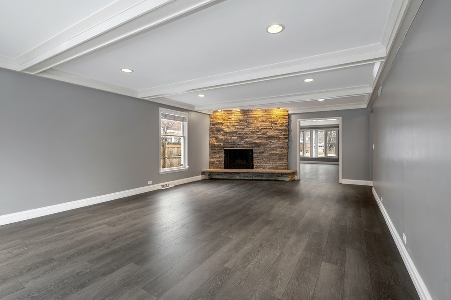 643 Robin Lane Glencoe, IL 60022 - Photo 9 of 32 an empty room with wooden floor fireplace and windows