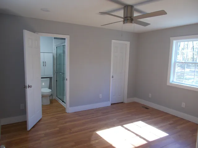 wooden floor in an empty room with a window