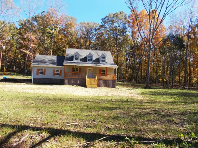 a front view of the house with a garden