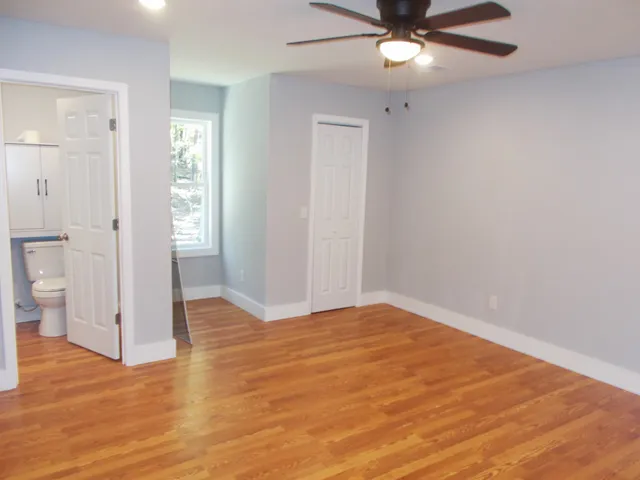a view of empty room with wooden floor