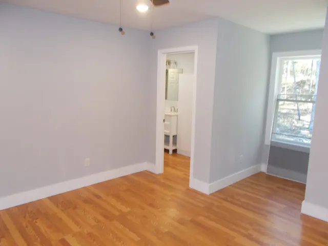 a view of a room with wooden floor