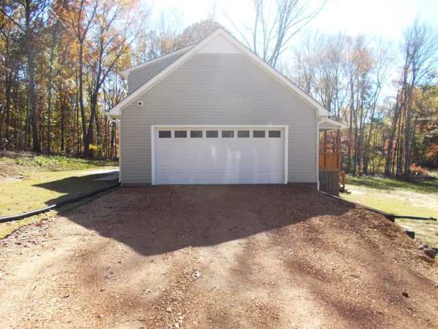 a backyard of a house with table and chairs