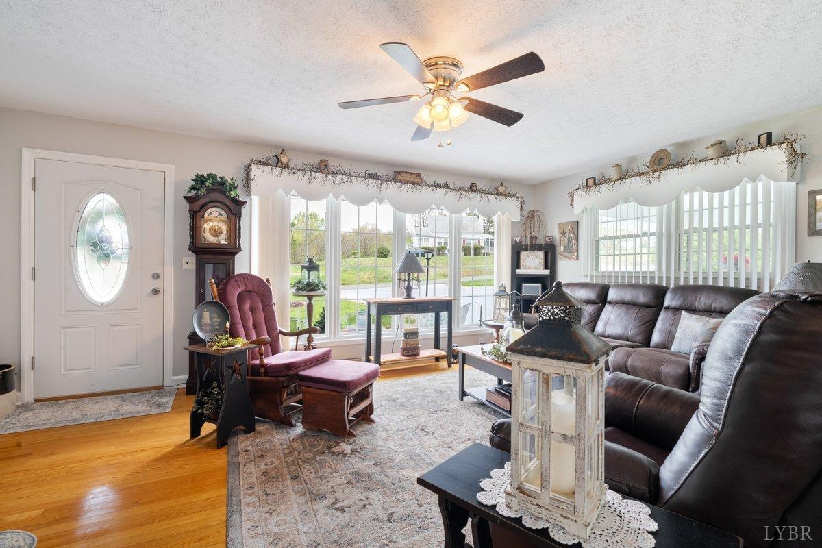 1568 Stone Mill Road Hurt, VA 24563 - Photo 5 of 36 a living room with furniture a fireplace and a large window
