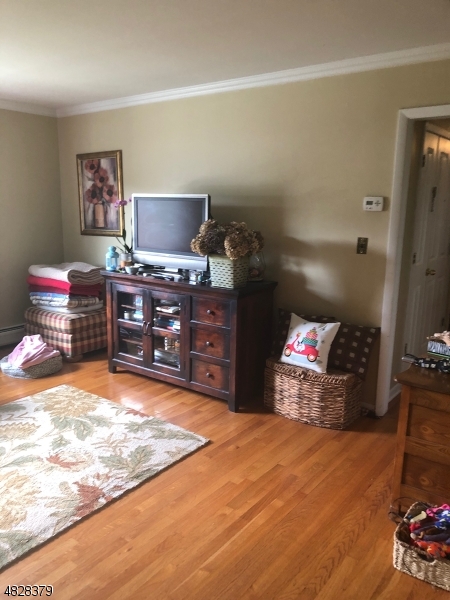 79 Rock Road, Unit 2 Hawthorne, NJ 07506 - Photo 12 of 13 a room with furniture and a flat screen tv