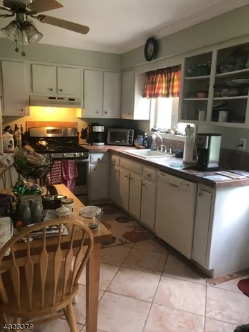 a kitchen with sink cabinets and window