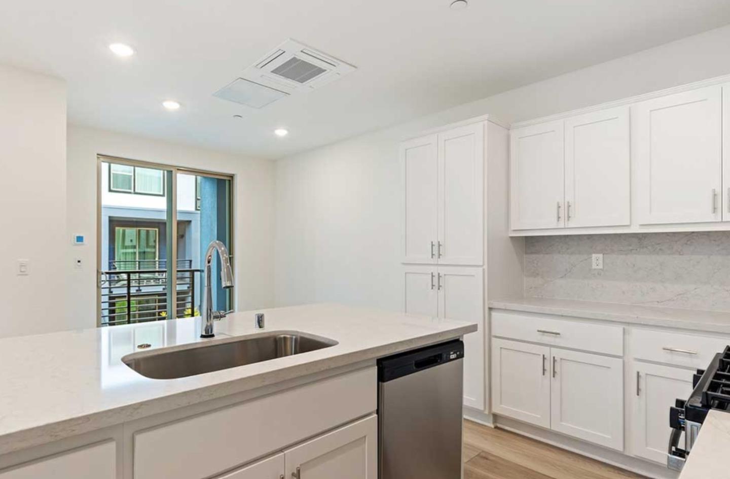 6681 Optimum Loop San Jose, CA 95119 - Photo 16 of 33 a kitchen with white cabinets and sink