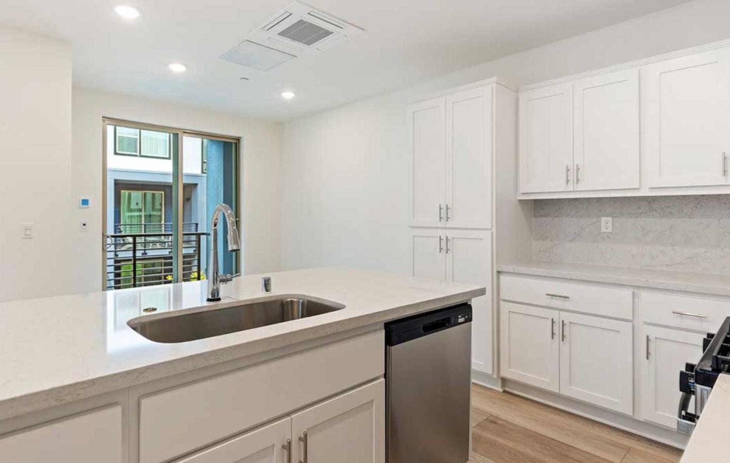 6681 Optimum Loop San Jose, CA 95119 - Photo 17 of 33 a kitchen with a sink and cabinets