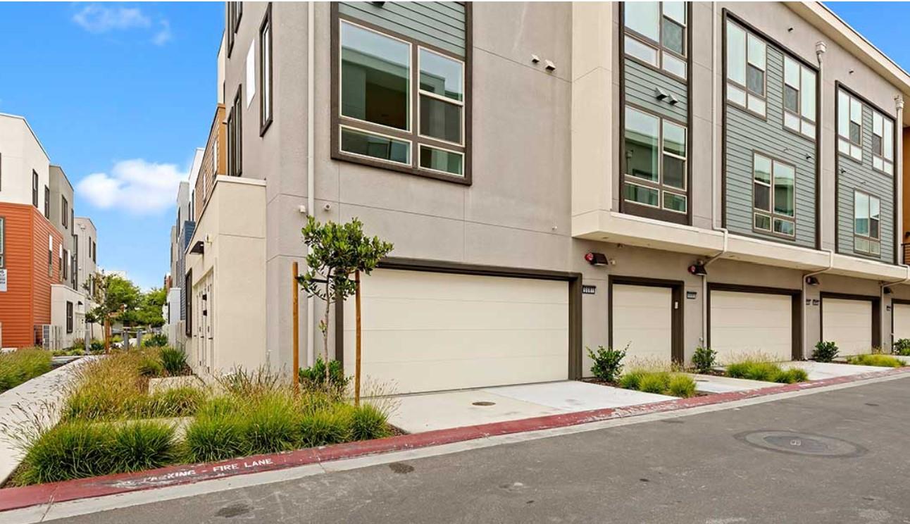 6681 Optimum Loop San Jose, CA 95119 - Photo 4 of 33 a front view of a building with a yard