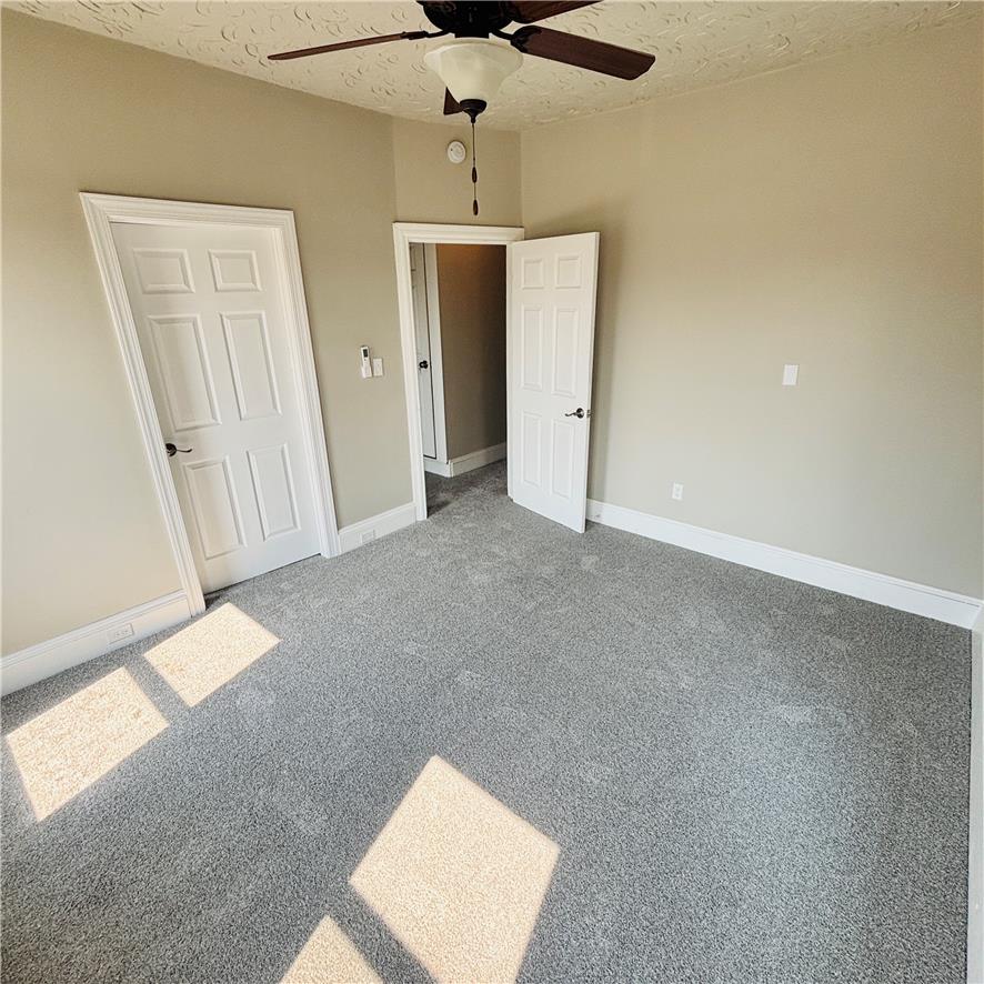718 Linden Street Bethlehem, PA 18018 - Photo 10 of 19 A well-lit room featuring light gray carpeting and a practical ceiling fan for comfort.