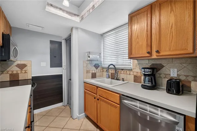 a kitchen with stainless steel appliances granite countertop a sink and cabinets