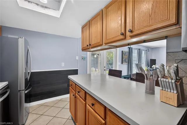 a kitchen with stainless steel appliances granite countertop a refrigerator and a stove