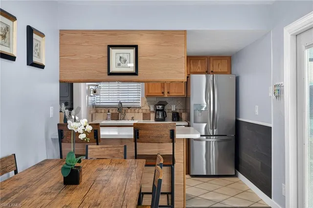 a kitchen with stainless steel appliances a refrigerator and wooden floor