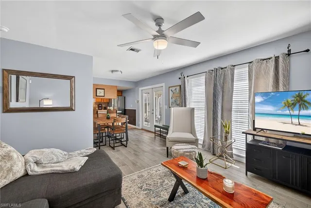 a living room with furniture and wooden floor