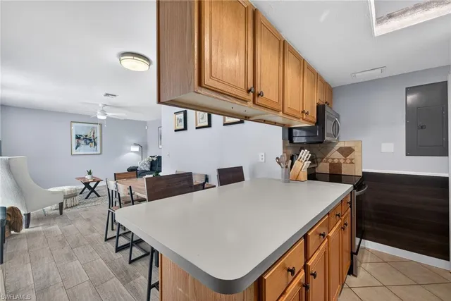 a kitchen with a table chairs and a refrigerator