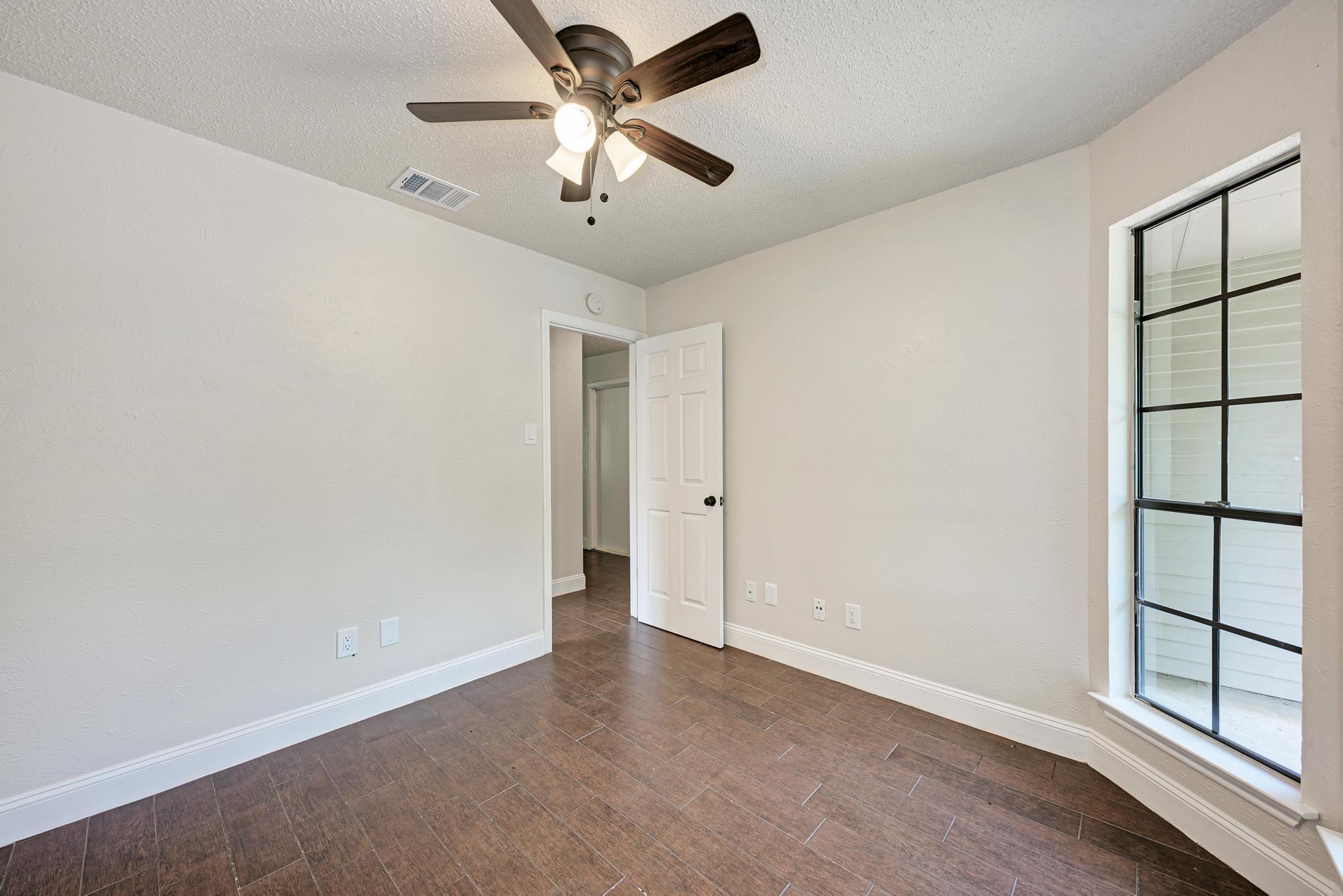 12108 Carnforth Drive Austin, TX 78753 - Photo 24 of 33 an empty room with windows and fan