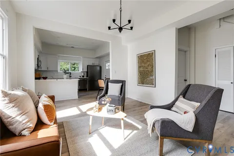 a living room with furniture and wooden floor