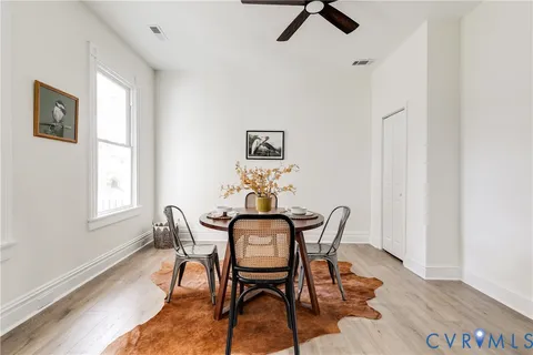 a view of a dining room with furniture and window