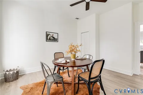 a view of a dining room with furniture and wooden floor