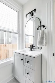 a bathroom with a sink and a mirror