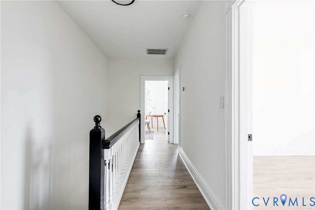 2413 Ingram Avenue Richmond, VA 23224 - Photo 26 of 43 a view of a hallway with wooden floor