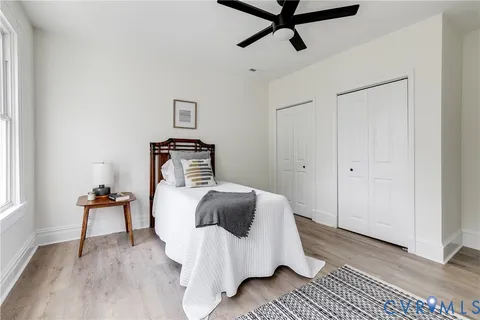 a bedroom with a bed and wooden floor