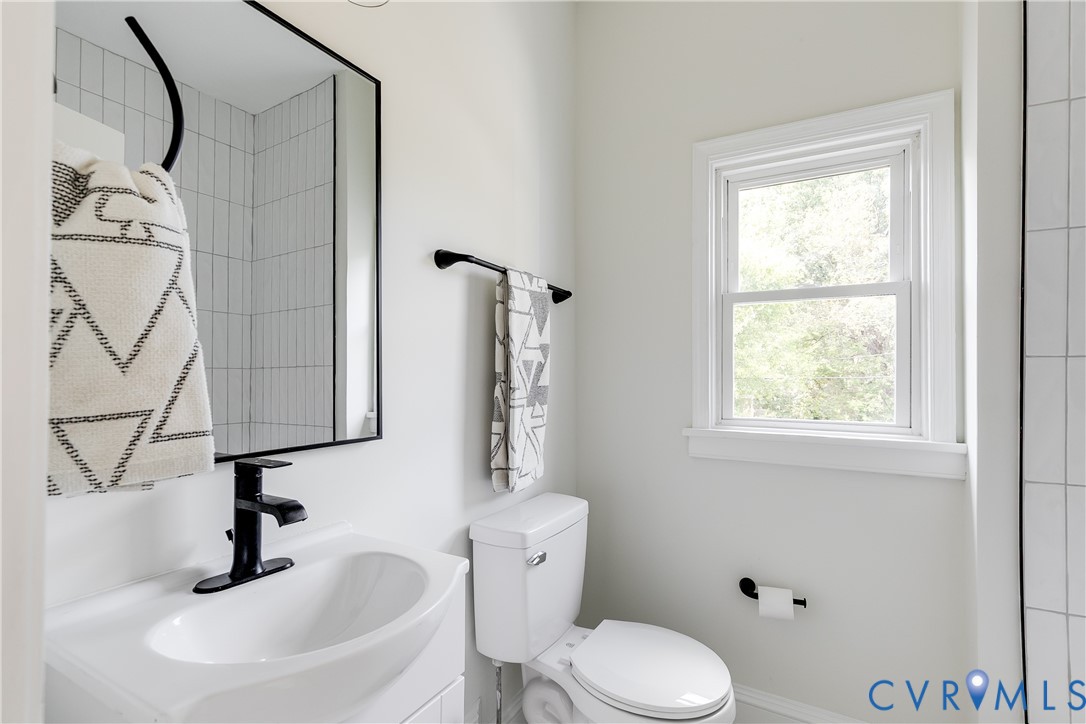 2413 Ingram Avenue Richmond, VA 23224 - Photo 31 of 43 a bathroom with a sink a toilet and a window