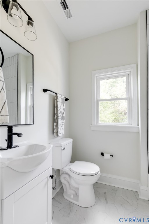 2413 Ingram Avenue Richmond, VA 23224 - Photo 32 of 43 a white toilet sitting next to a bathroom sink