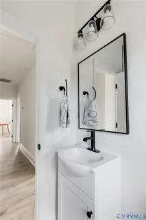 a bathroom with a sink a mirror and vanity
