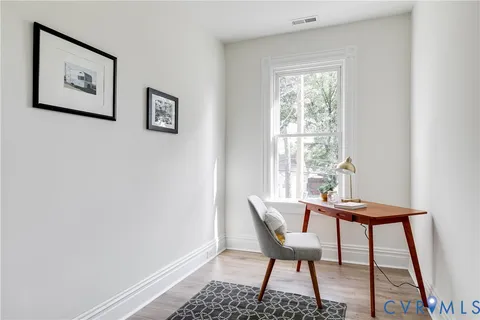 a view of a room with a table and chairs