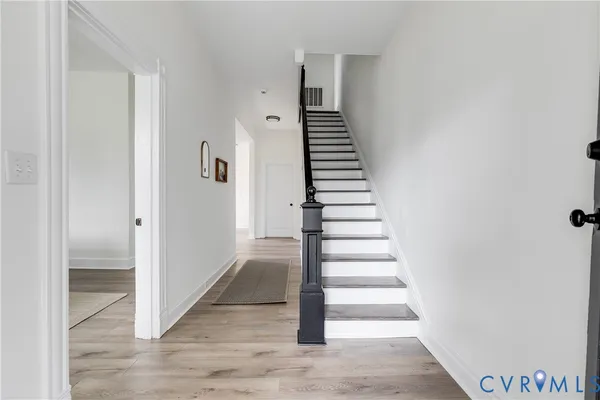 a view of an entryway with wooden floor