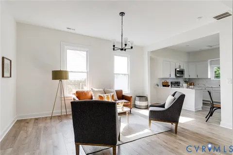 a living room with furniture and a chandelier